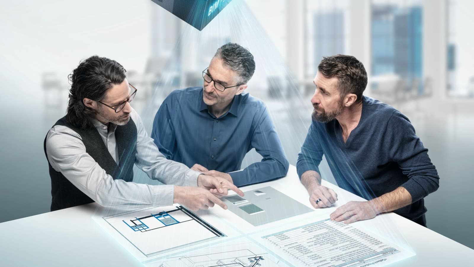 Plánovači zahĺbení do diskusie okolo stola so symbolom BIM Plánovači zahĺbení do diskusie okolo stola so symbolom BIM